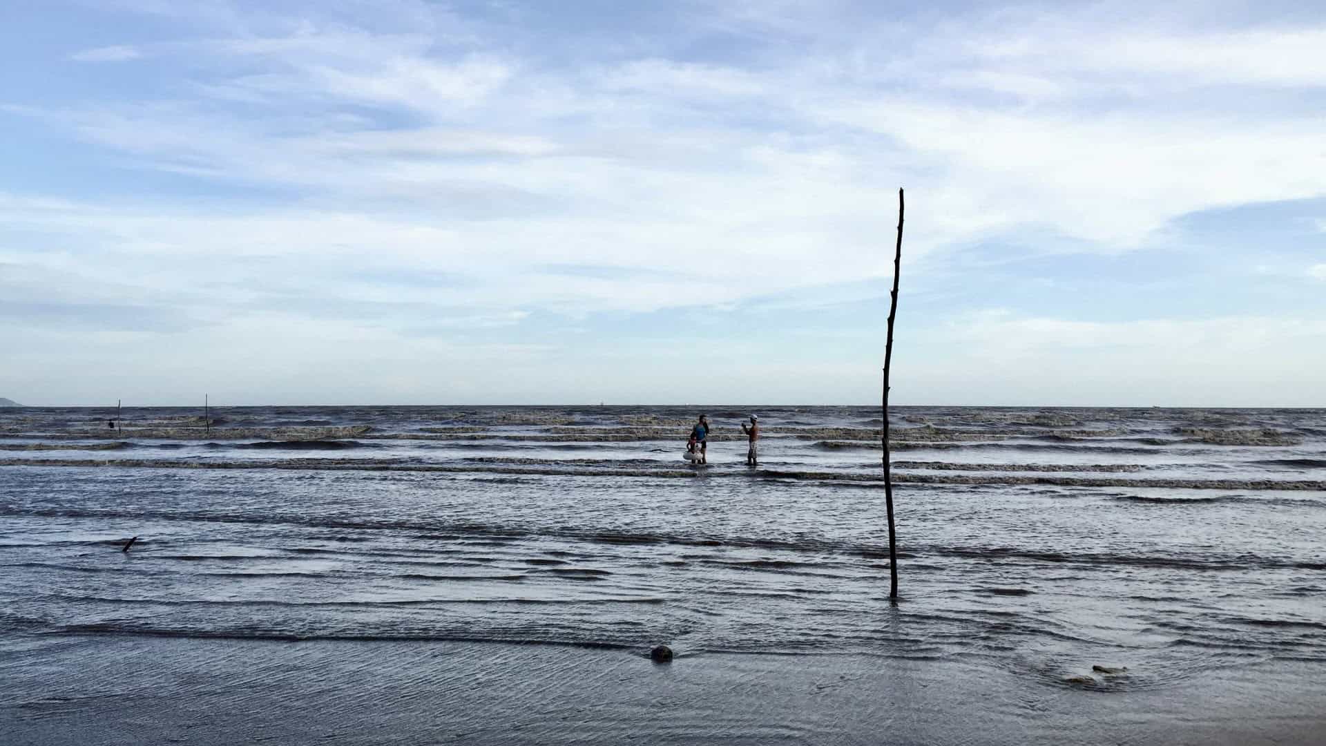 People enjoying the sea at 30/4 Beach in Can Gio, Vietnam