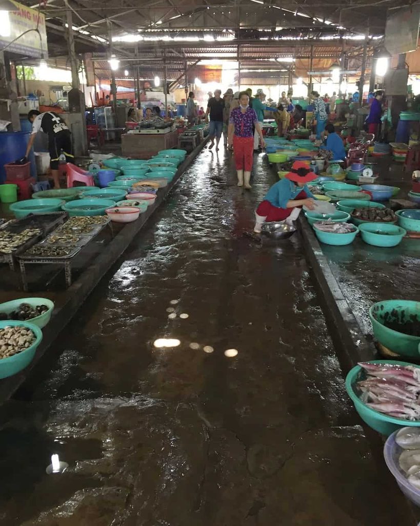 Fresh seafood displayed in baskets at a market in Can Gio, Vietnam