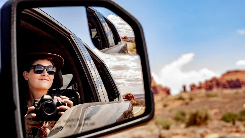 Traveler photographing a desert road trip through the American Southwest