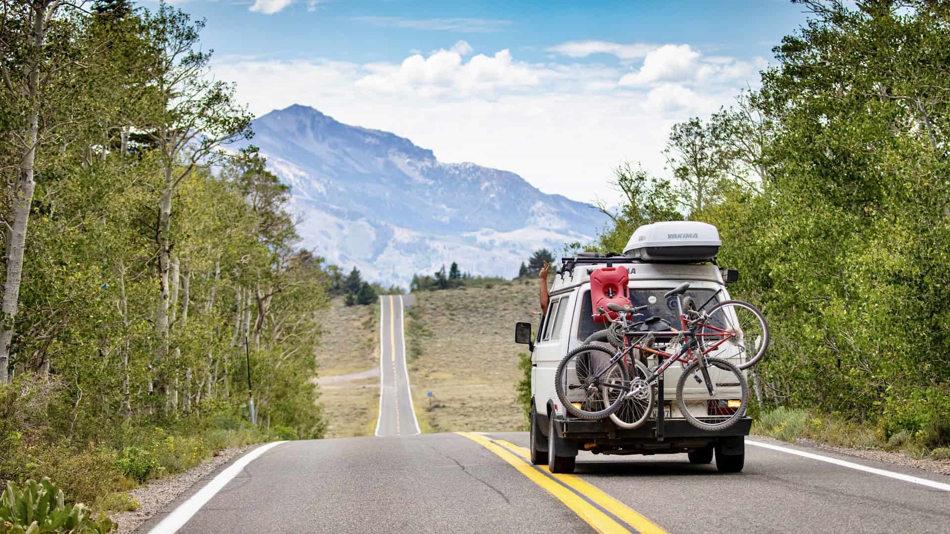 Camper van driving on a scenic USA road trip through the mountains