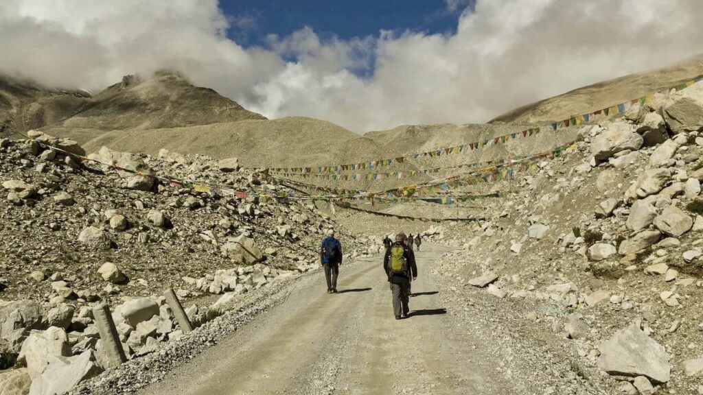 Trekkers walking through a high-altitude Himalayan landscape in Nepal