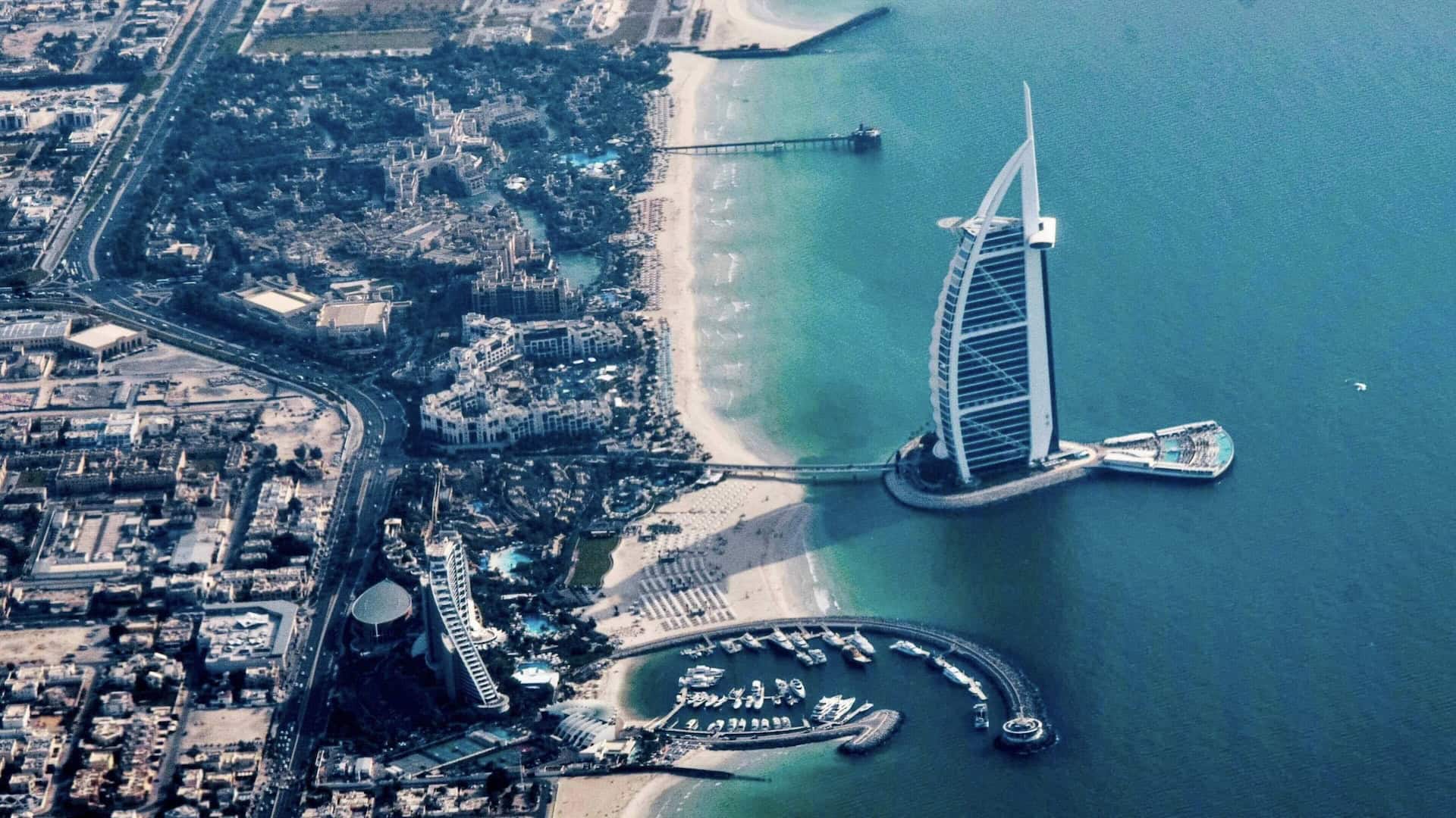 Burj Al Arab luxury hotel overlooking the Arabian Gulf at sunset