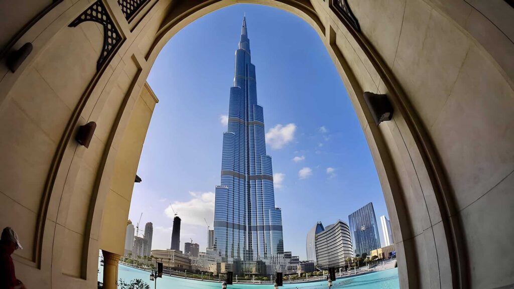 Burj Khalifa rising above downtown Dubai, viewed through an architectural arch