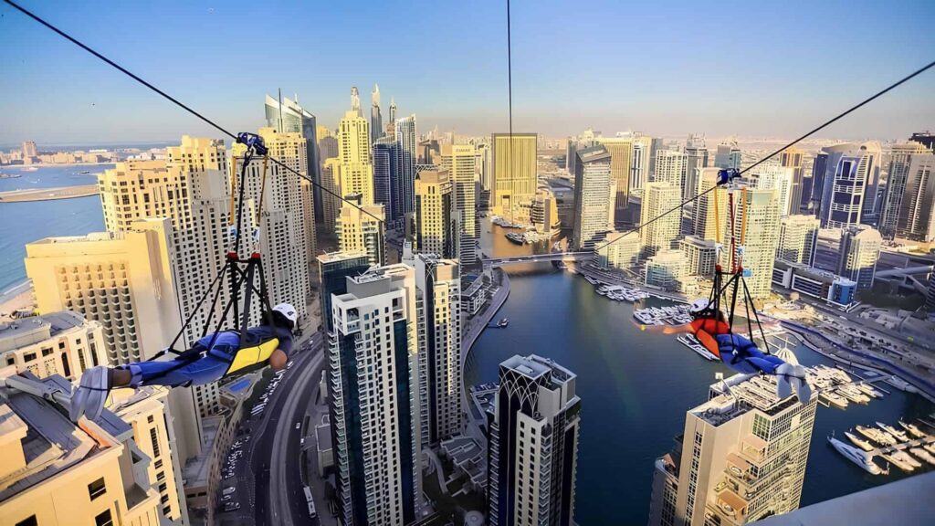 Visitors ziplining above Dubai Marina’s skyscrapers and waterfront