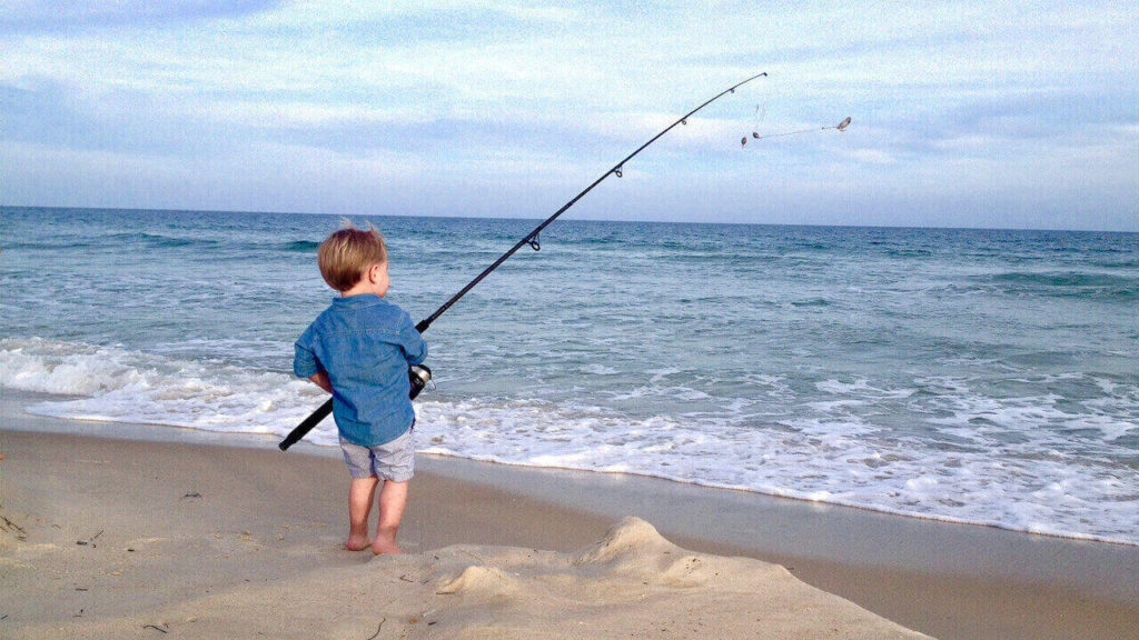 boy kid fishing white sand beach california