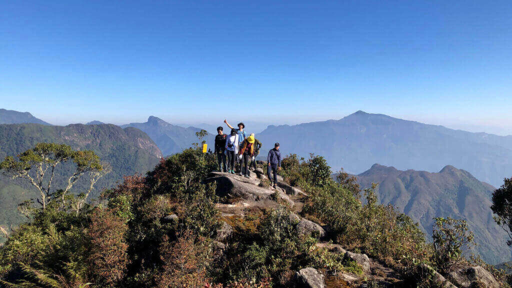 a team reach the peak of bach moc luong tu mountain