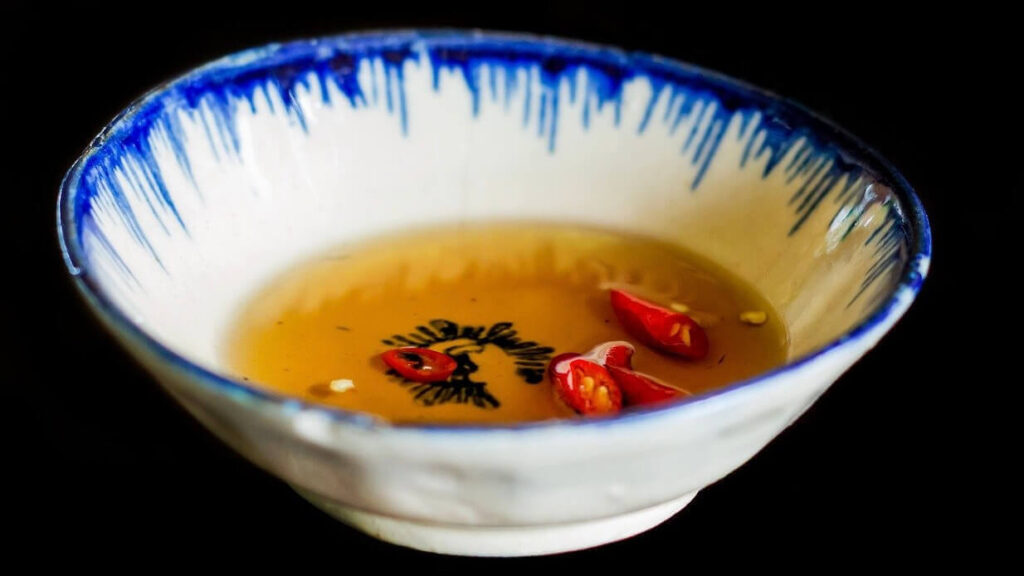 a small bowl of fish sauce with chili