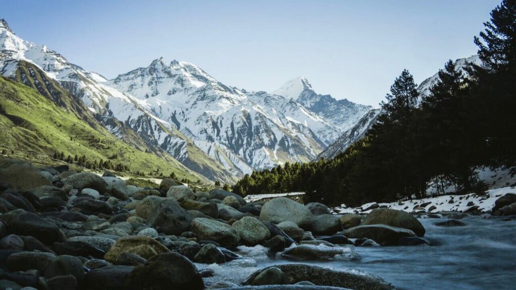 a river flows through the Himalayas, one of the most famous mountain ranges in the world