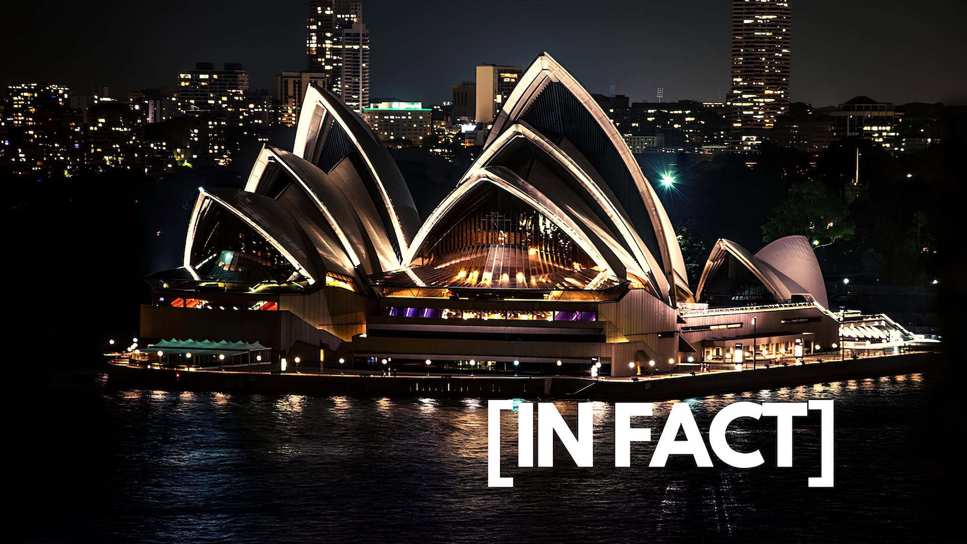 Sydney Opera House illuminated at night beside Sydney Harbour, featured in a guide to 20 famous buildings around the world