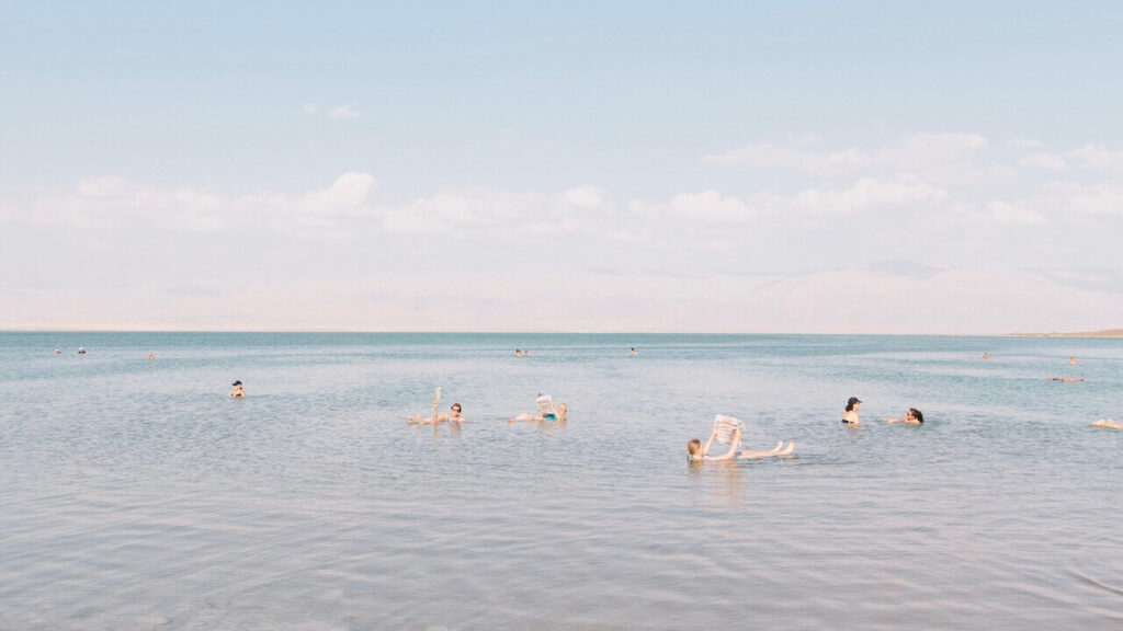 People are reading while floating in the Dead Sea