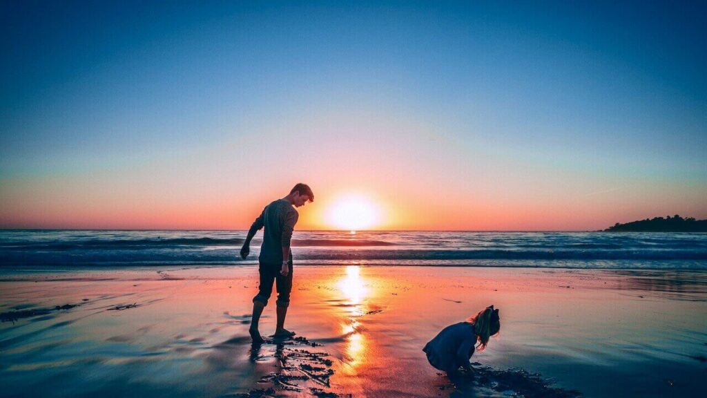 A boy and girl are playing in Carmel Beach, California