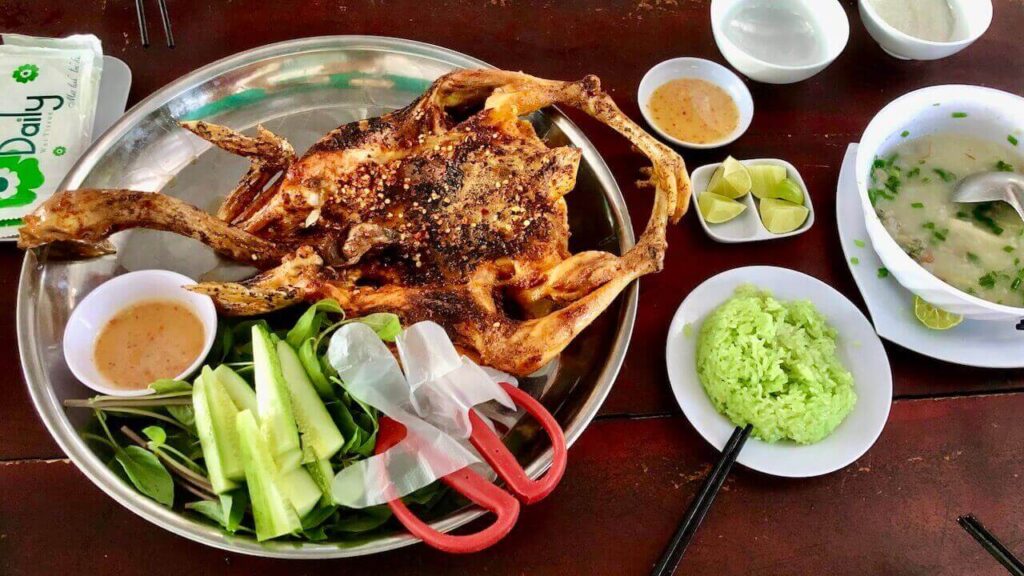 The delicious grilled chicken with pandan sticky rice and oyster porridge at Gà Nướng Suối Tre, Long Sơn