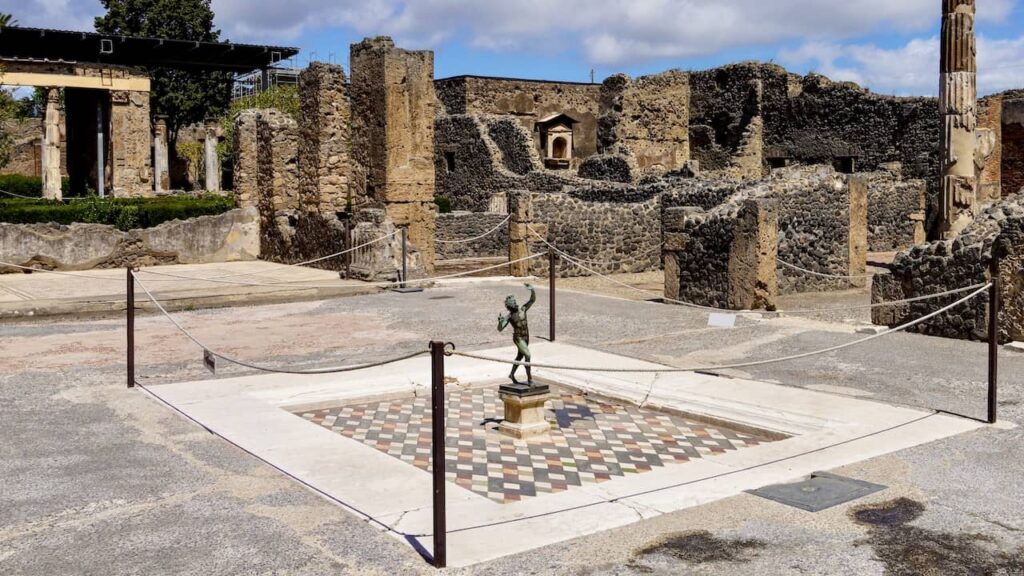 The bronze statue of a faun in House of the Faun in Pompeii travel guide