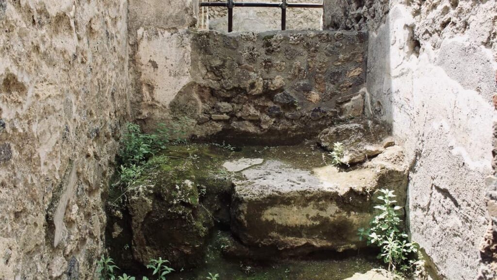 A bed in one of the rooms in the Lupanar Pompeii