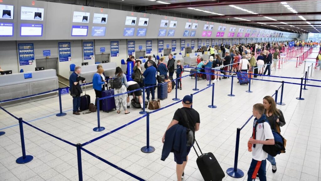 travelers are lining up when check-in at the airport