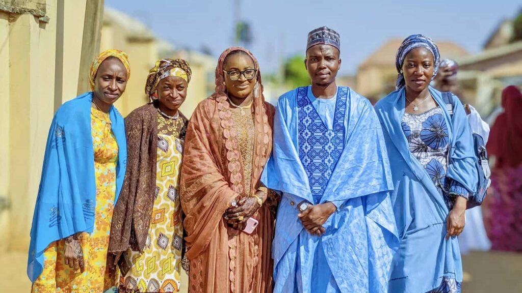 West African wedding guests wearing aso ebi coordinated outfits showing unity and cultural wedding traditions