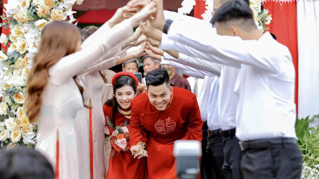Vietnamese wedding ceremony with bride and groom in traditional red attire during cultural wedding traditions