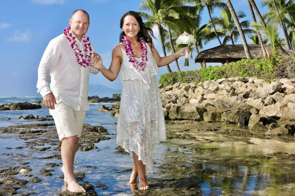 Hawaiian wedding lei exchange ceremony on beach symbolizing love and cultural wedding traditions