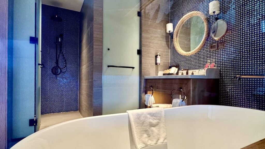 Bathroom with bathtub and walk-in shower in the Classic King Room at Movenpick Resort Phan Thiet