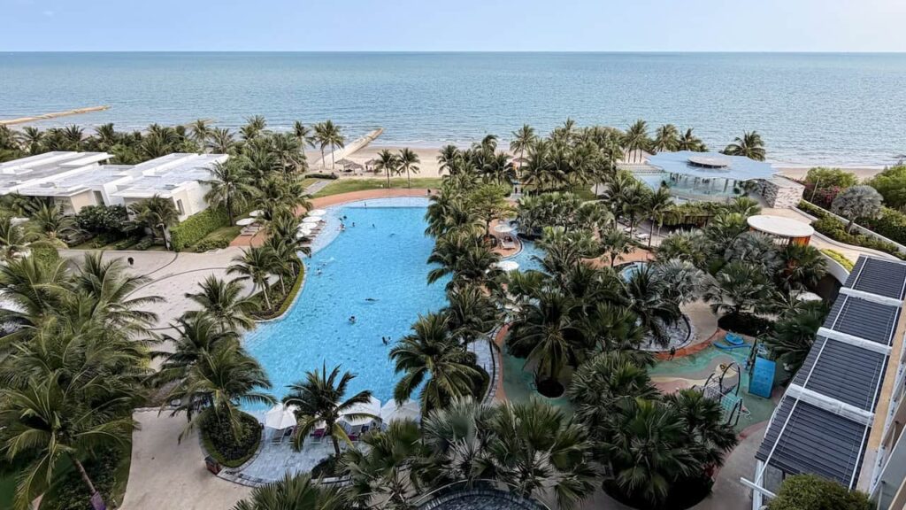 Ocean view overlooking the swimming pool and beach from the Classic Sea View King room at Dhawa Ho Tram.
