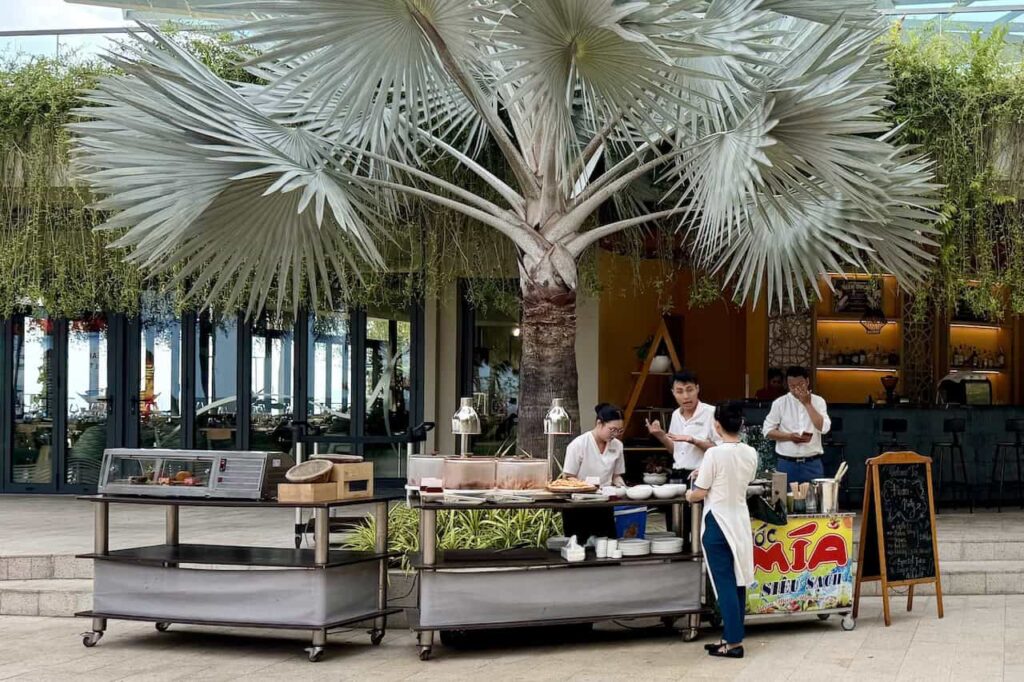Outdoor snack station serving pizza and refreshments near the swimming pool at Dhawa Ho Tram.