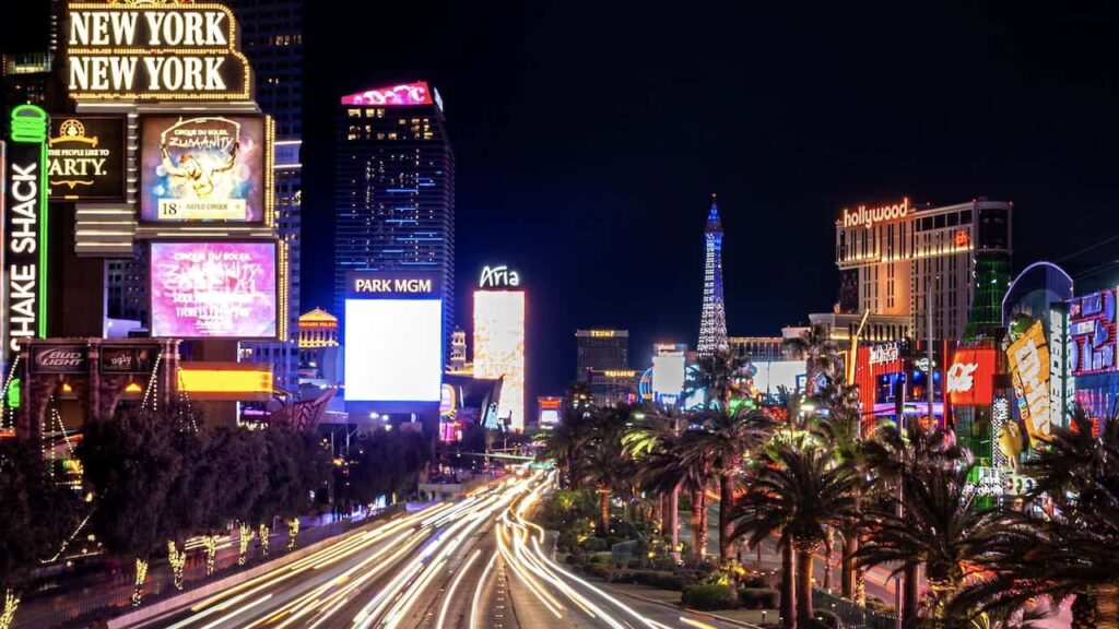 Las Vegas Strip illuminated at night with hotels, casinos, and palm trees
