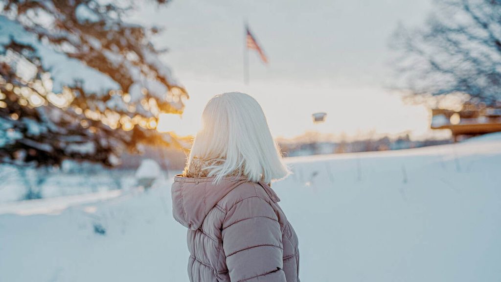 Traveler enjoying a snowy winter landscape in the USA at sunset